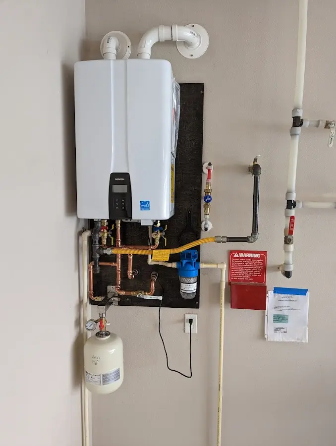 Professional plumber installing copper piping in a Depew home